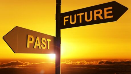 Past and future directional signs at sunset, time travel concepts, life choices, reflection, destiny, visual metaphor for decision-making, glowing sky.