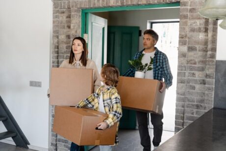 Moving boxes into a modern home during a house purchase or move-in.