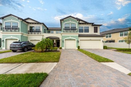 Elegant Tampa townhouse with a beautifully landscaped driveway and modern exterior design.