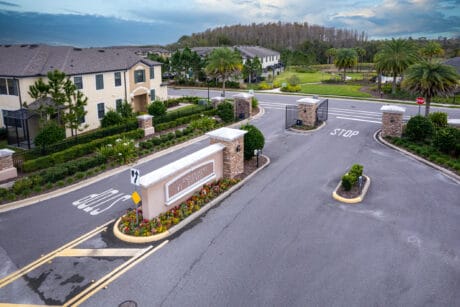 New residential community entrance with gated access and lush landscaping, Tampa Homes Sold.
