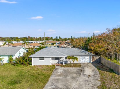 Modern single-story home with spacious driveway in Tampa, Florida.