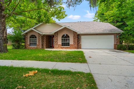 Brick and stucco single-family home with a well-maintained front yard in Tampa, FL.