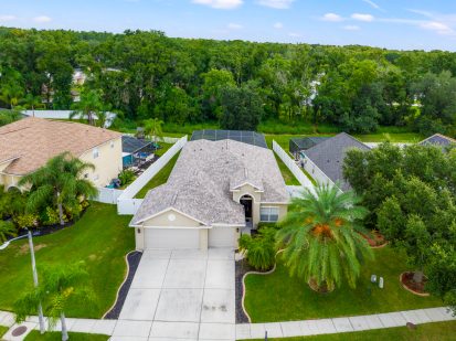 Spacious single-family home in Tampa with landscaped yard and lush greenery.