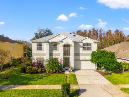 Bright white luxury home for sale in Tampa with landscaped yard and modern design.